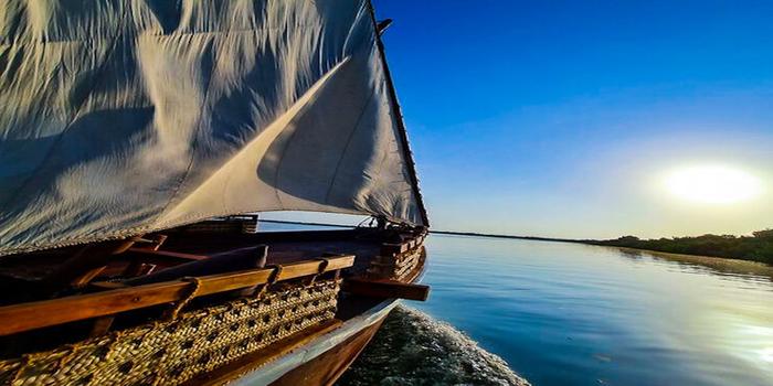 Traditional Dhow at the shore during sunset.
